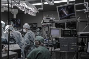 An operating room filled with surgeons in the middle of surgery