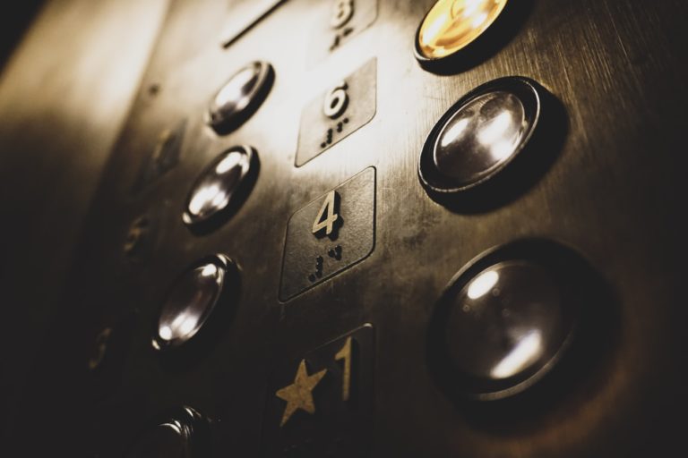 A close up of elevator buttons
