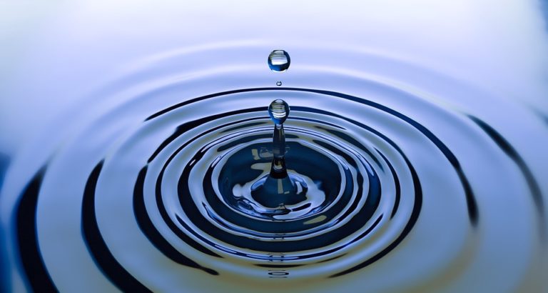 Close up photo of a water drop creating ripples